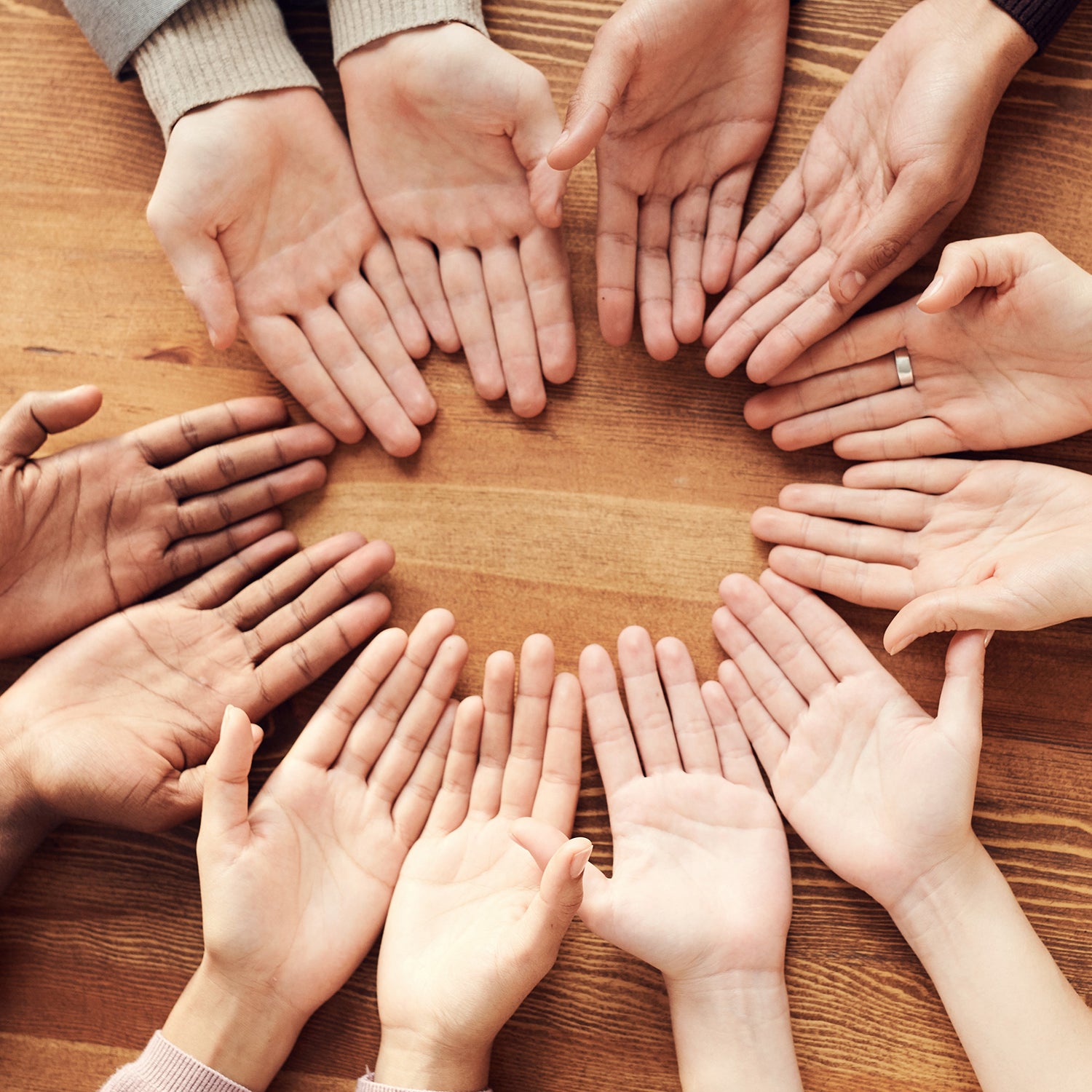 picture of people putting hands together